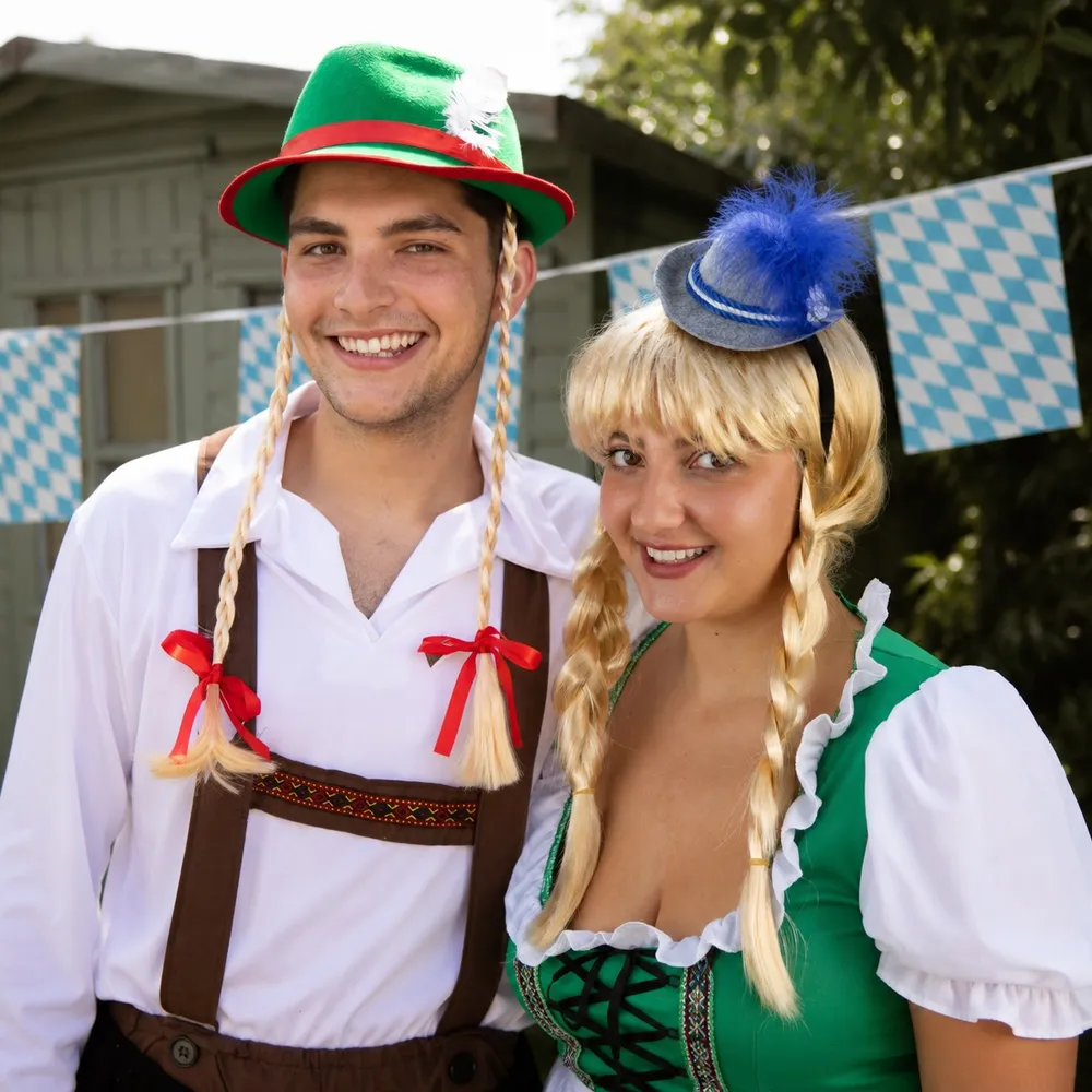 Couple dressed in matching Oktoberfest lederhosen and dirndl outfits