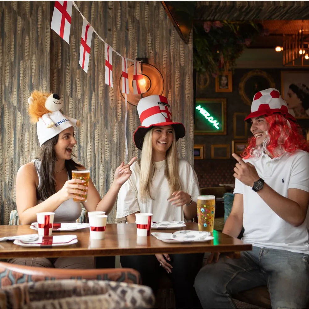 England football supporters wearing bucket hats and accessories in a pub